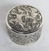A white metal lidded caddy having Tibetan style decoration to lid, 104.7g.