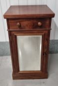 A mahogany pot cupboard having bevelled edge mirror to the door with single drawer over.