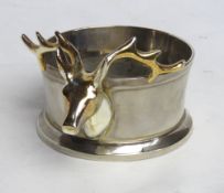 A silver plated wine bottle coaster in stag head design.