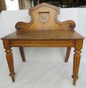 A low hall table bearing regiment emblem Nec Aspera Terrent (Difficulties be damned).