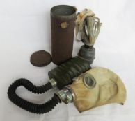 Two gas masks, one with tin.