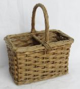 A wicker double bottle picnic carrier.