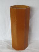 A hexagonal wooden umbrella stand.