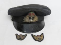 A WWII Royal Navy officers service dress peaked cap bearing label for Gieves Ltd London together