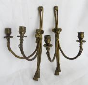 A pair of brass wall candle sconces each with Rams head to centre.
