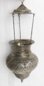 A white metal Ner Tamid (eternal light) altar lamp.