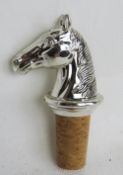 A silver plated bottle stopper, horse head design.