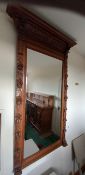 A large over mantle mirror having heavily carved oak frame. 1730cm high, 100cm wide.