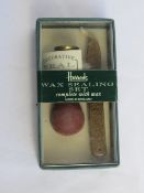 A Harrods wax sealing set.