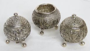 A white metal cruet set having heavily carved decoration throughout, 178.2g.