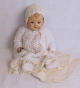 A vintage doll having jointed limbs, open mouth with teeth and dimples.