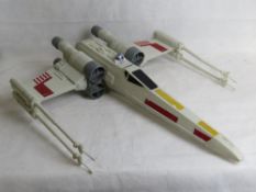 A Star Wars model X wing fighter.