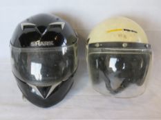 Two contemporary motorbike helmets, for decorative use only.