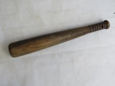 A 20th century wooden truncheon.