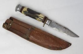 A William Rodgers Sheffield hunting knife in leather sheath.