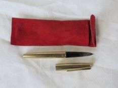 A gold plated Parker pen in Cartier sleeve.