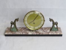 A French Art Deco marble mantle clock having pair of decorative cast metal animals upon,