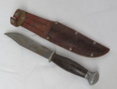 A hunting knife in leather sheath.