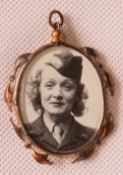 A vintage double sided glazed pendant with military themed photographs within.