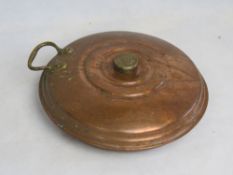 A copper foot warmer / hot water bottle.