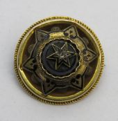 A Victorian yellow metal and black enamel brooch having central diamond, 2cm dia, 3.1g.