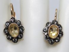 A pair of gold plated silver earrings having citrine coloured stone with white stones surrounding