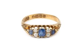 A sapphire and diamond half hoop ring, the graduated cushion-shaped sapphires spaced by pairs of