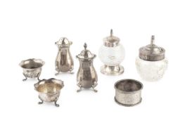 A small collection of silver, comprising a silver mounted cut glass jar, another, two pepper