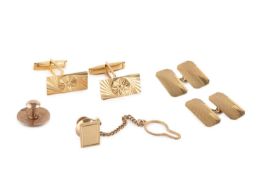 A pair of cufflinks, each rectangular panel with star engraved decoration, on hinged baton fittings,