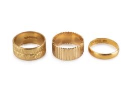 An 18ct gold wedding band, with engraved decoration, hallmarked for London 1968, a 22ct gold wedding