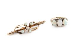An opal three stone ring, the slightly graduated oval cabochon opals in claw setting, with