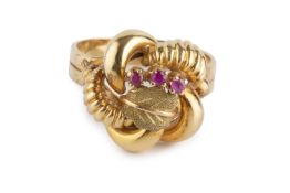 A stone set dress ring, the twisted panel with foliate and bead accents, highlighted with a trio