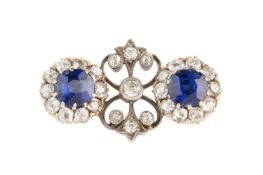 A diamond set panel brooch, designed as two old-cut diamond clusters, each centred with a cushion-