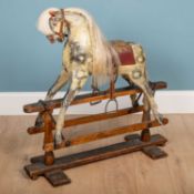 A grey painted rocking horse