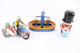Three vintage tinplate toys.