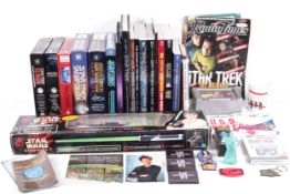 A collection of Star Trek books, PC games & a 'Lightsaber'.