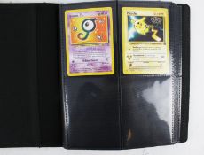 A collection of 66 assorted Pokemon cards in a binder.