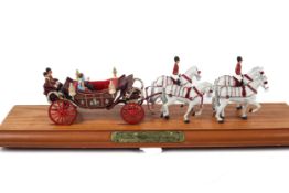 A Corgi The Queen Mothers Century State Landau coach and horses.
