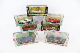 Seven diecast sports cars. 1:43 scale, including a Ferrari GT 202, 8414 AC Shelby Cobra, etc.