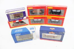 Eight OO gauge wagons.