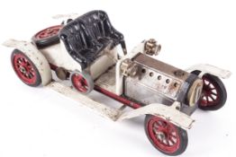 A Mamod live steam car. Complete with boiler and burner pan.
