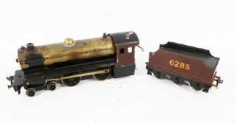A Bassett Lowke O gauge live steam locomotive and tender.