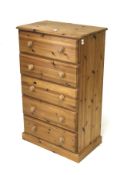 A contemporary pine chest of five drawers.