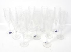 A set of twelve Royal Doulton champagne flutes.