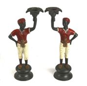 A pair of novelty cast metal candlesticks.
