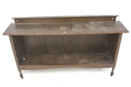 A vintage low bookcase on castors. With one adjustable shelf.