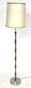 A 1960s standard lamp. Teak and metal on a round base.