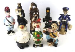 A collection of eight assorted novelty china decanter bottles.