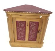 A contemporary pine corner cupboard.