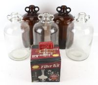 Five demijohns and a selection of wine production equipment.